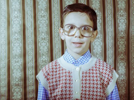 Smiling child with glasses in vintage clothes. Close up shot