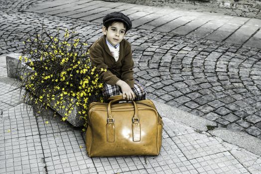 Child on a road with vintage bag. Vintage clothes style