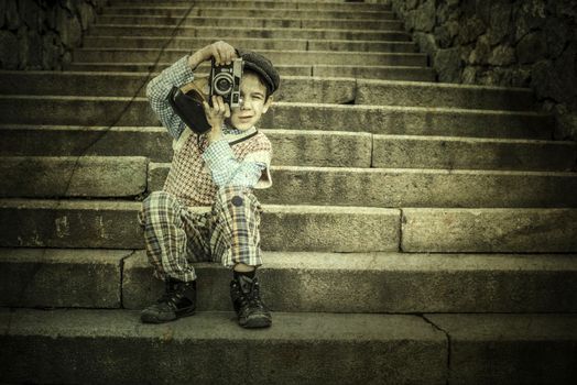 Child with vintage camera. Exterior stairs