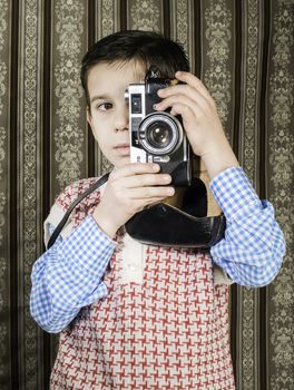 Boy with vintage camera. Vintage clothes