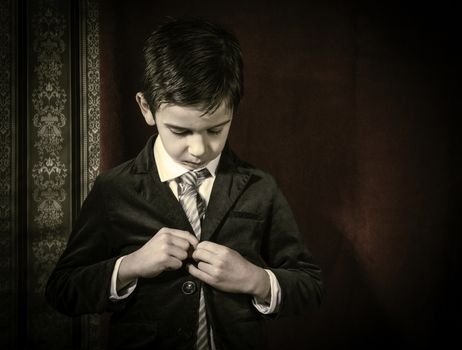 Boy in vintage black suit and tie