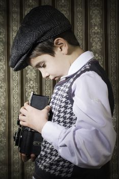 Boy with vintage camera. Vintage clothes