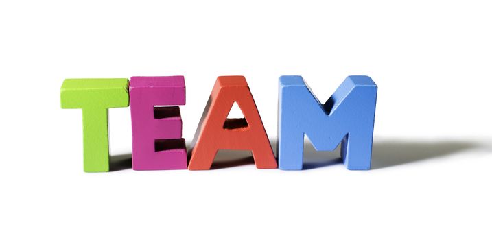 Multicolored text team made of wood. White background