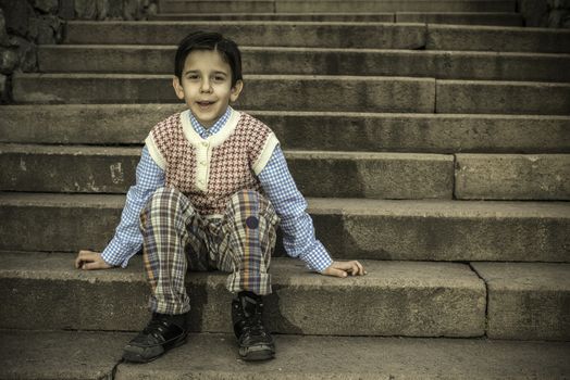 Child sitting on stairs. Vintage image