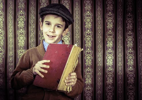 Child with red vintage book. Vintage clothes and hat