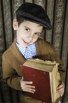 Child with red vintage book. Vintage clothes and hat