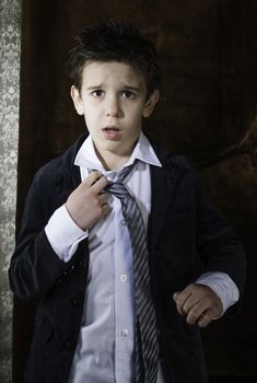 Boy in vintage black suit and tie