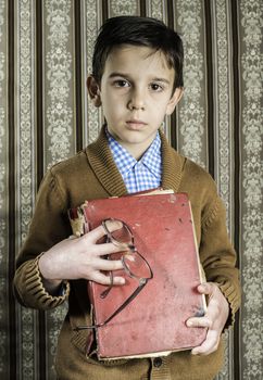 Child with red vintage book. Vintage clothes