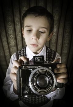 Boy with vintage camera. Vintage clothes