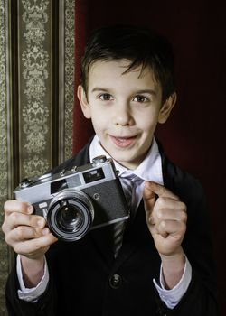 Boy with vintage camera. Vintage clothes