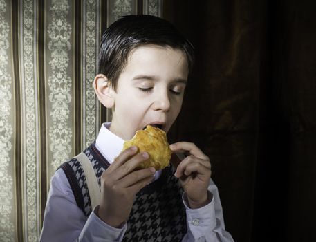 Child who eat donut. Vintage clothes and background