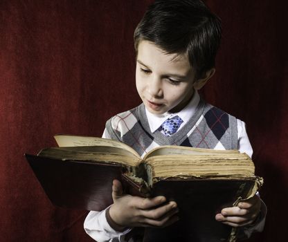 Child with red vintage book. Vintage clothes