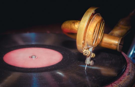 vinyl record and fragment of vintage gramophone closeup