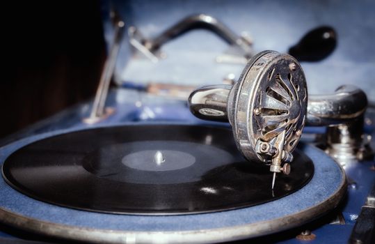 vinyl record and fragment of vintage gramophone closeup