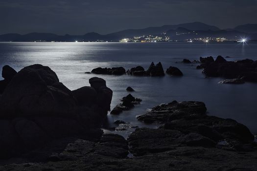Cliff immersed in the sea illuminated by the reflected light of the moon are the protagonists in this marvelous panorama of Capo Ferrato beach in the south of Sardinia.
