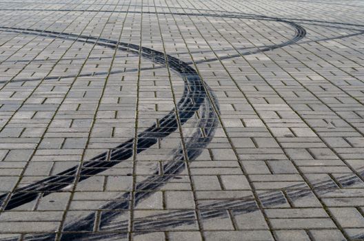 black marks of braking tires on car wheels on the road