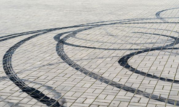 black marks of braking tires on car wheels on the road