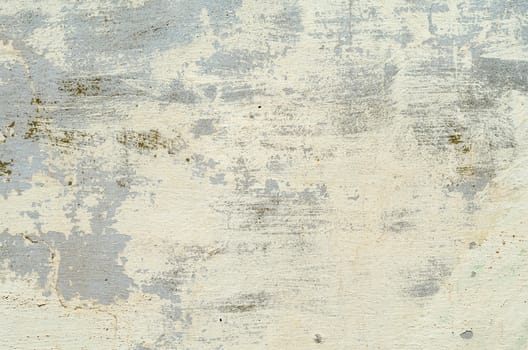 beige texture of the old concrete wall with the remains of paint