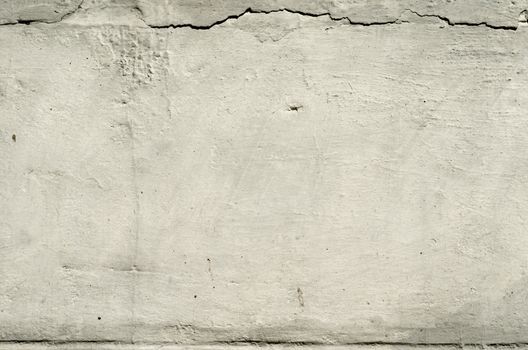 white texture old concrete wall with remains of plaster with cracks