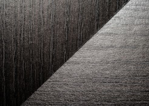 intersection of two black wooden surfaces closeup