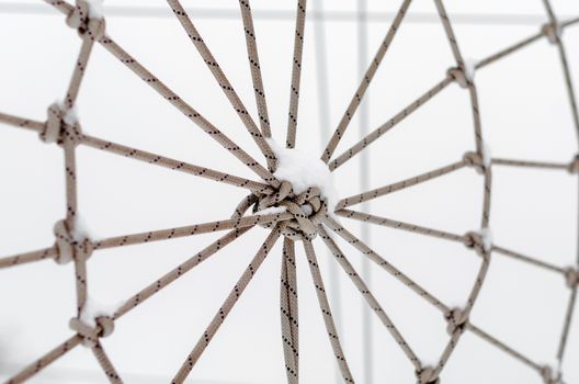 tied rope in the snow close up