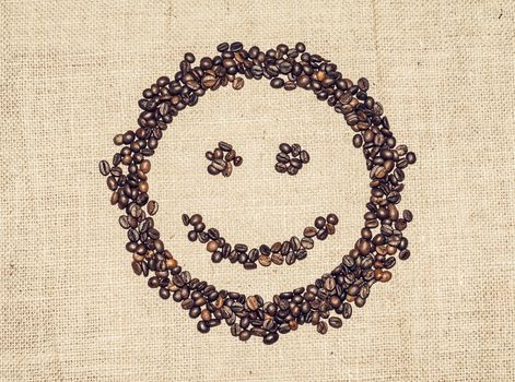smiling face formed by coffee grains on coarse cloth