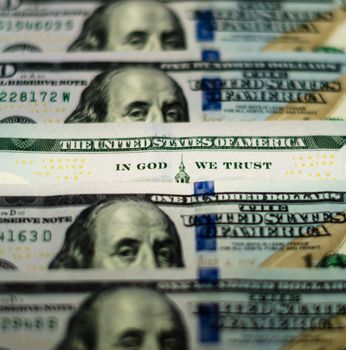 bill hundred US dollars closeup phrase in god we trust