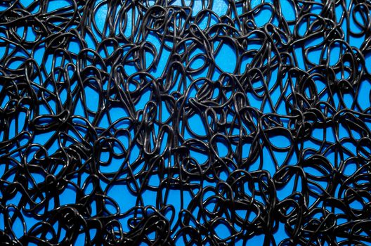texture pattern of dark brown rubber on a blue background