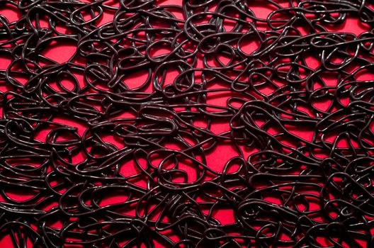 texture pattern of dark brown rubber on a red background