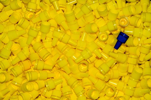 texture yellow plastic caps with one blue lid