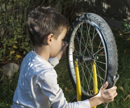 Child who fix bikes. Boy and bicycle