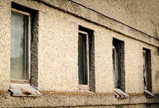 old dirty wall of a building with windows
