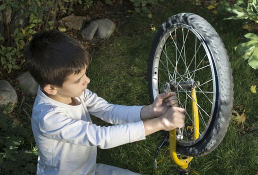 Child who fix bikes. Boy and bicycle