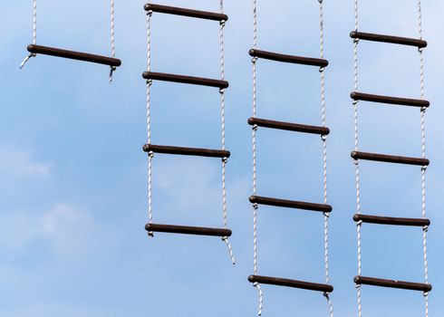 rope ladder against a blue sky and clouds