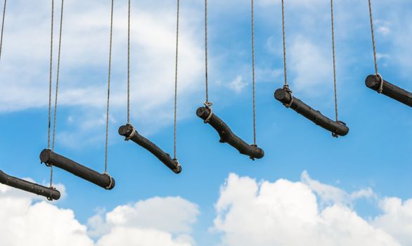 rope ladder against a blue sky and clouds