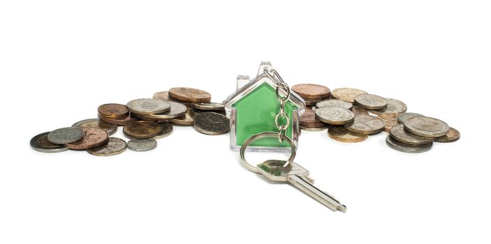Coins and green house key ring. White isolated studio shot