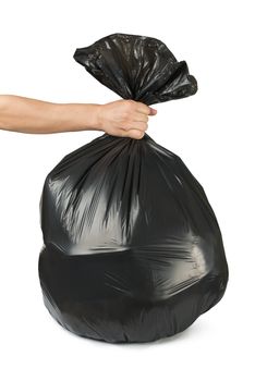 Hand holding black bag of rubbish. White isolated studio shot.