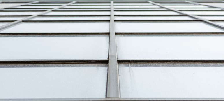 empty windows of a gray high concrete building