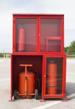 Fire extinguishers and fire fighting equipment. In the yard of an industrial building