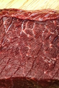 Raw beef steak meat on kitchen board close up