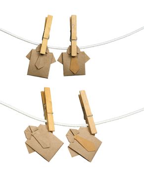 Origami brown shirts on rope. White isolated