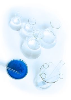 Laboratory glassware equipment. Laboratory beakers and blue liquid.