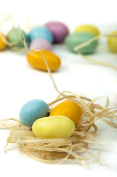 Small multicolored eggs white isolated