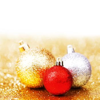 Beautiful christmas balls on abstract glitter background close-up