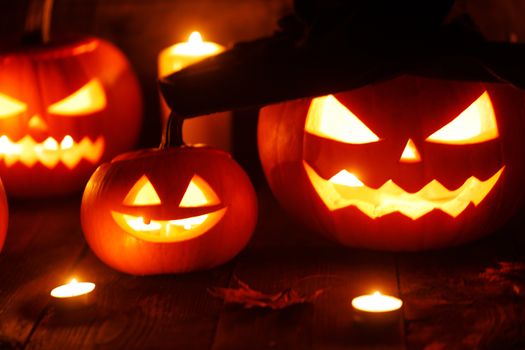 Jack O Lantern Halloween pumpkin with witches hat, spiders on web and burning candles