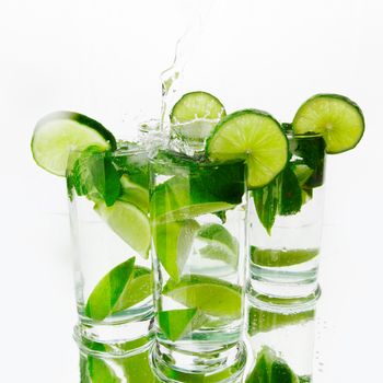 Party mojito cocktails with lime and mint isolated on white background