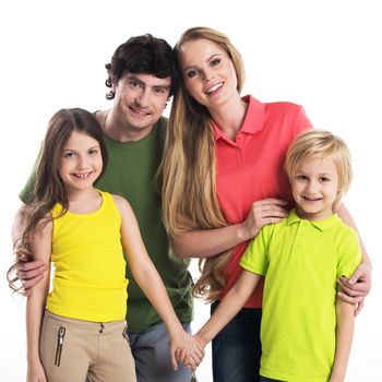 Studio portrait of family in colorful clothes with two children isolated on white background