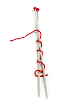 Knitting skewers and red yarn white isolated