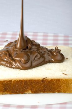 Pouring chocolate on a slice of bread