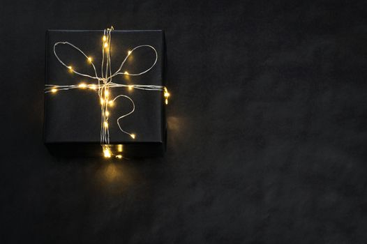 Black Present Box wrapped with string lights